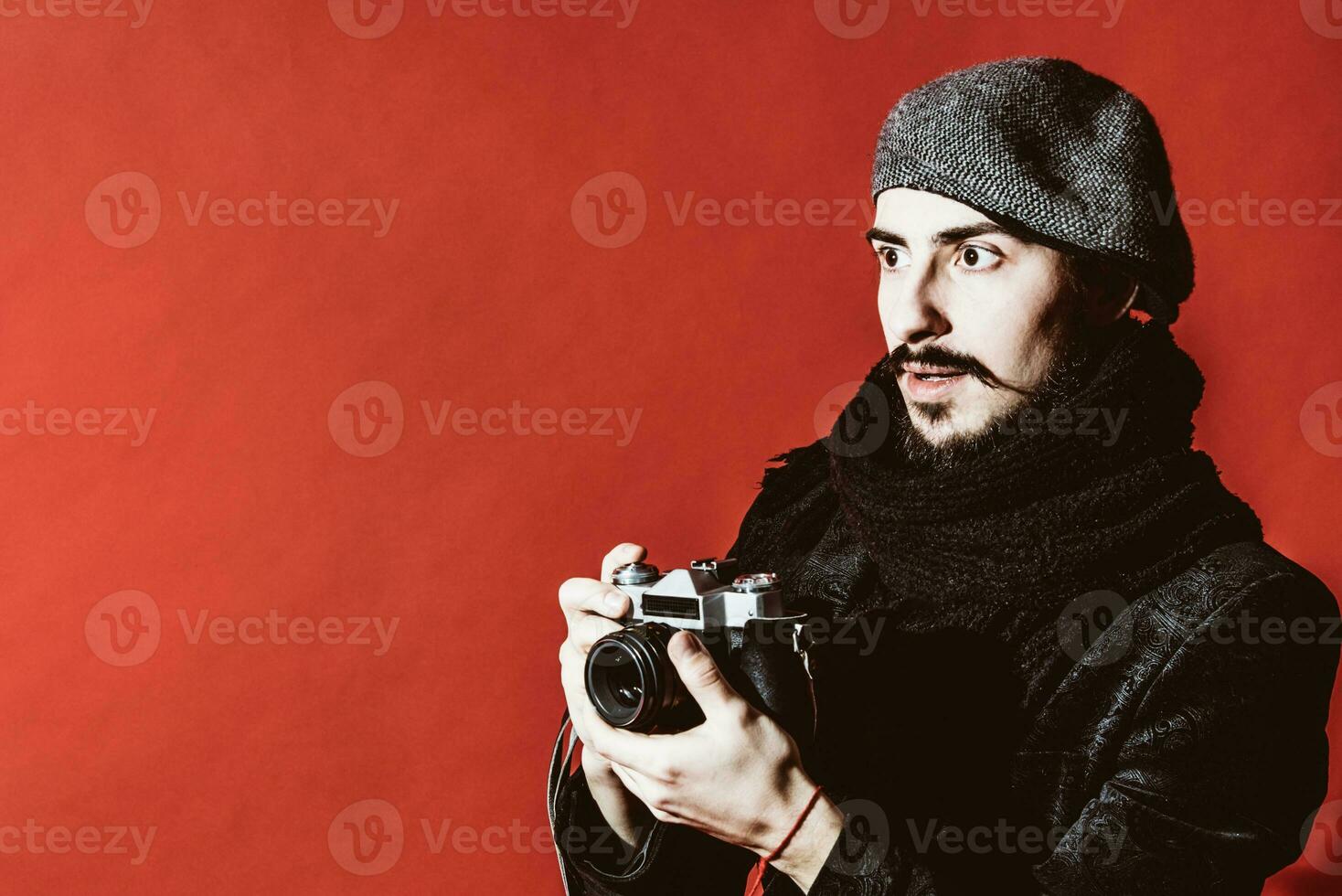 creative photographer posing in studio with camera photo