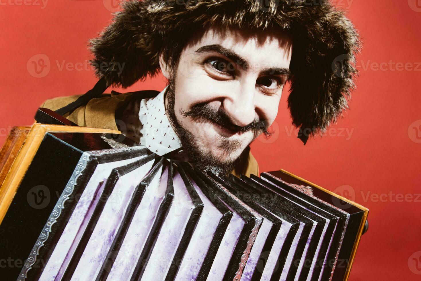 a very positive man with an accordion posing in the studio photo