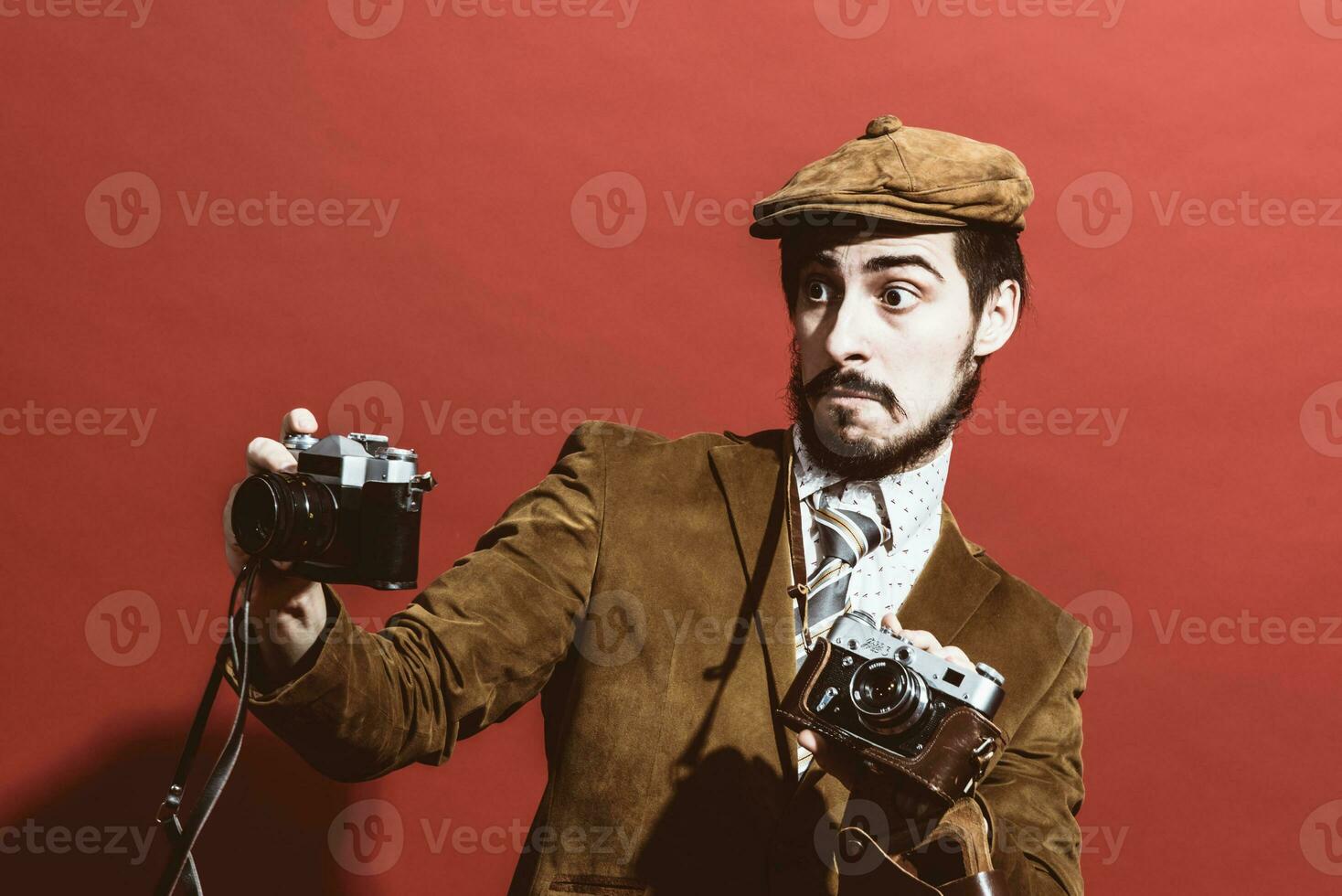 very positive photographer posing in studio with cameras photo