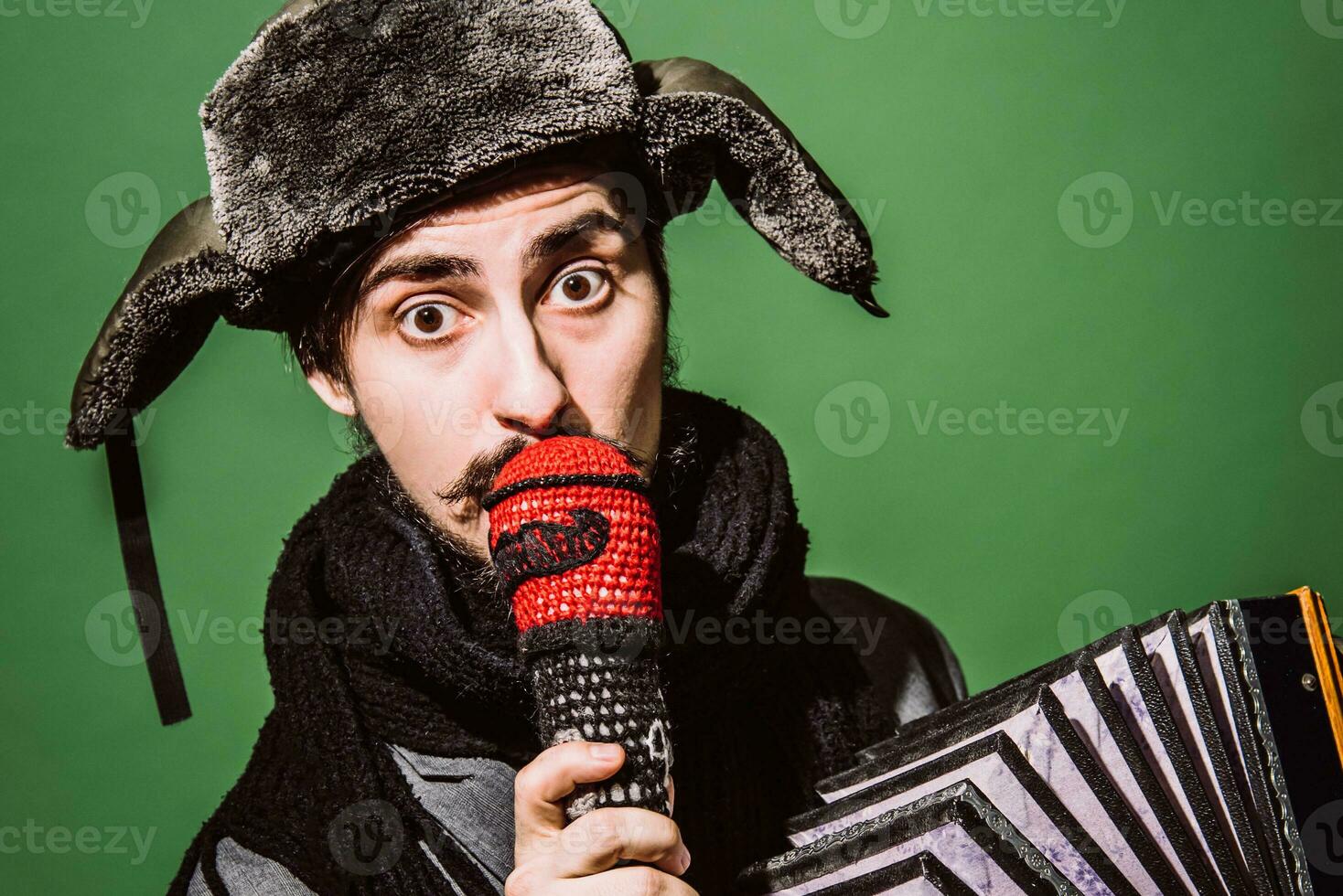 a very positive man with an accordion posing in the studio photo