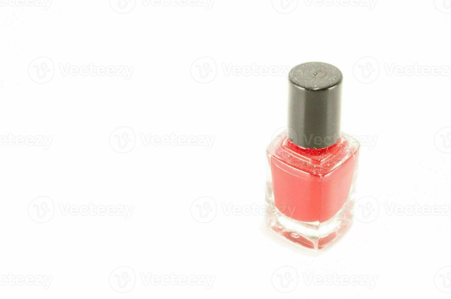 a bottle of red nail polish on a white background photo