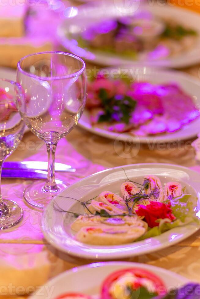 Served festive table with snacks, glasses, glasses, cutlery and napkins for a banquet photo