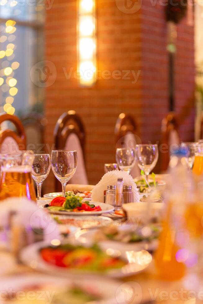 Served festive table with snacks, glasses, glasses, cutlery and napkins for a banquet photo