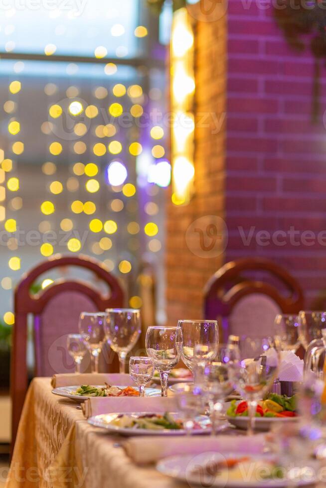 Served festive table with snacks, glasses, glasses, cutlery and napkins for a banquet photo