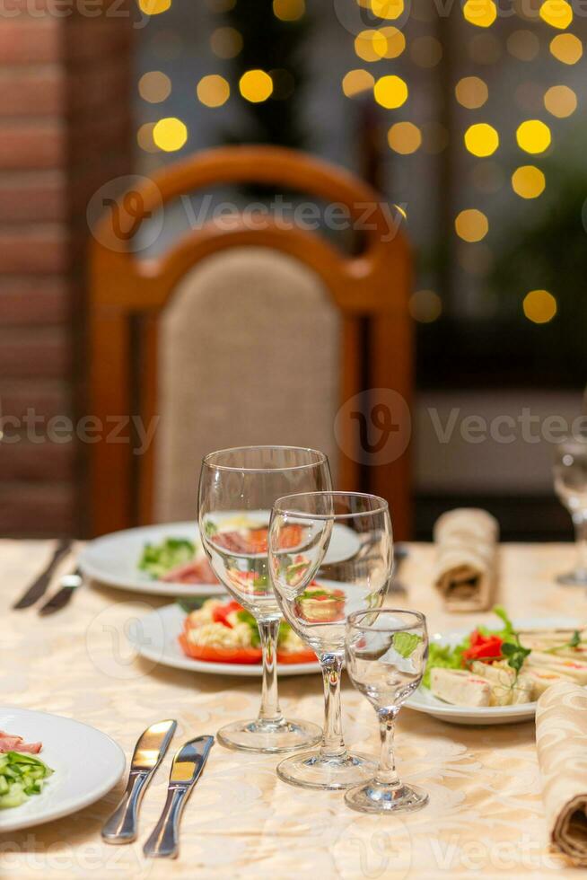Served festive table with snacks, glasses, glasses, cutlery and napkins for a banquet photo