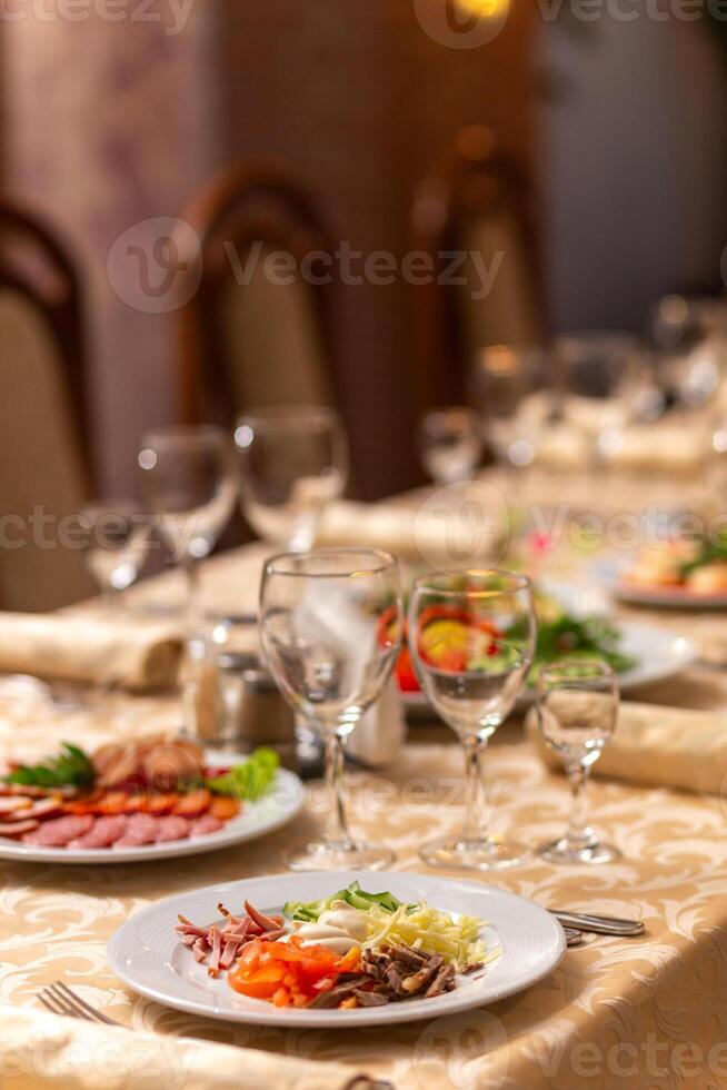 Served festive table with snacks, glasses, glasses, cutlery and napkins for a banquet photo