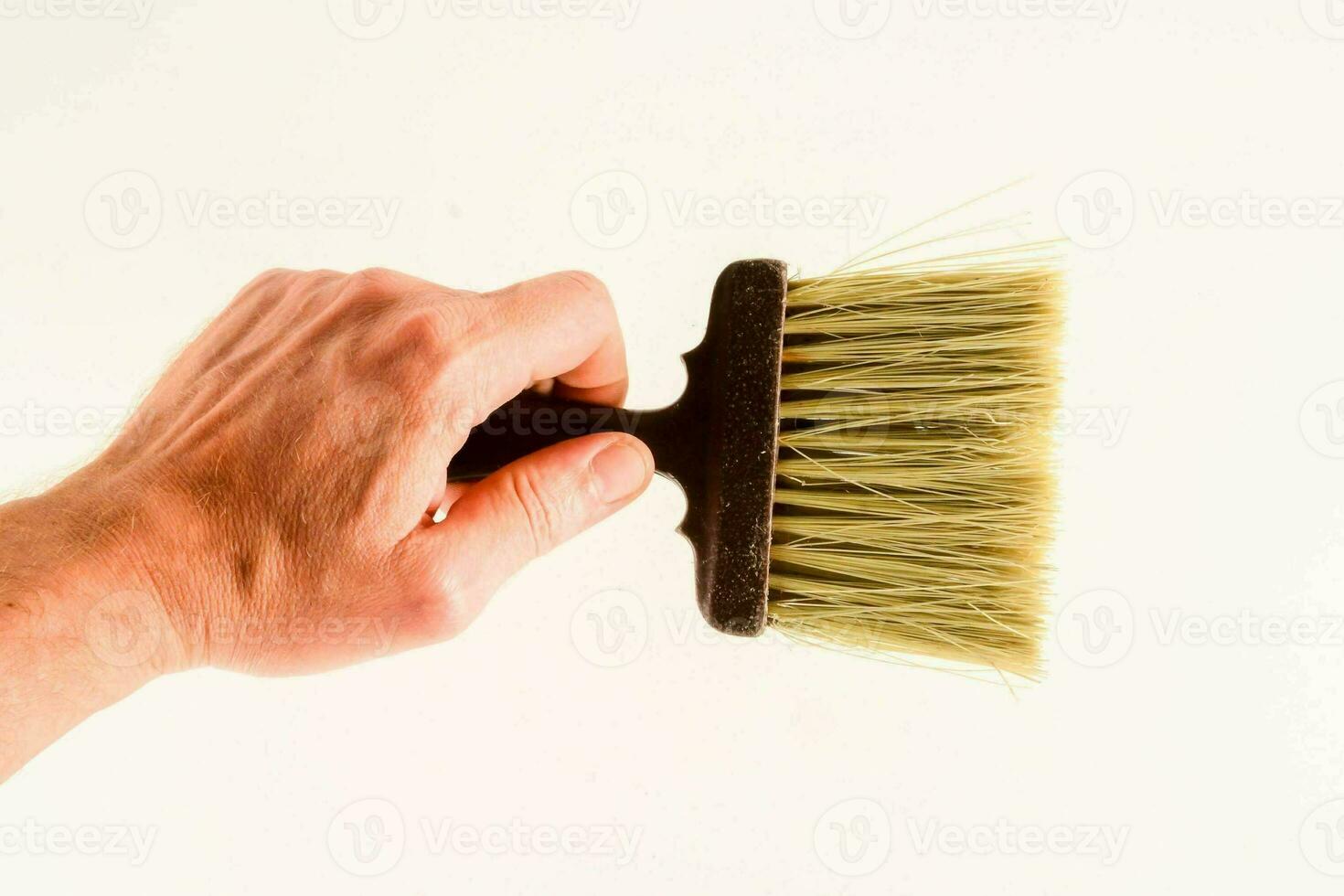 a hand holding a brush on a white background photo