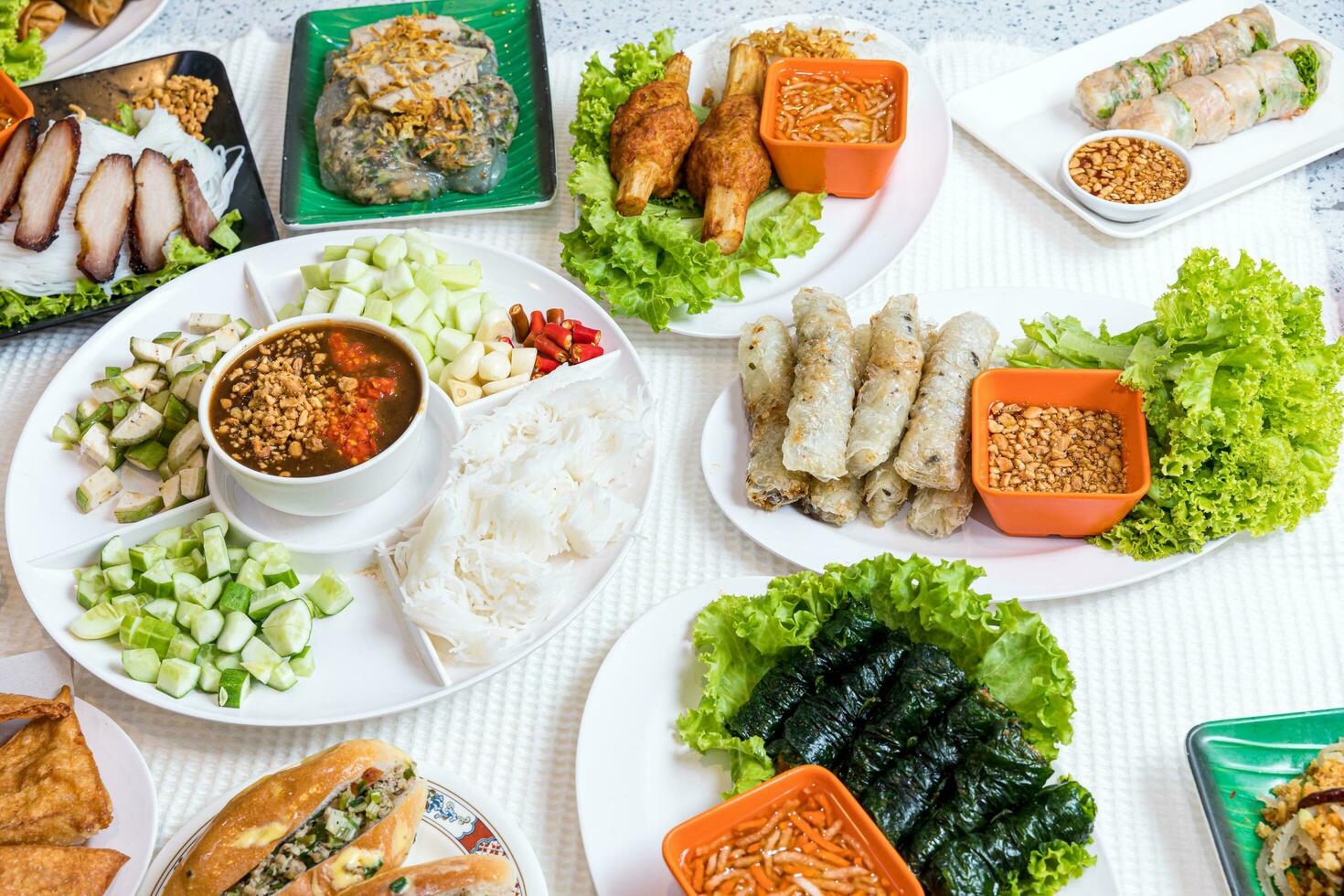 Assorted asian dinner, vietnamese food. Pho ga, pho bo, noodles, spring rolls, Nham due photo