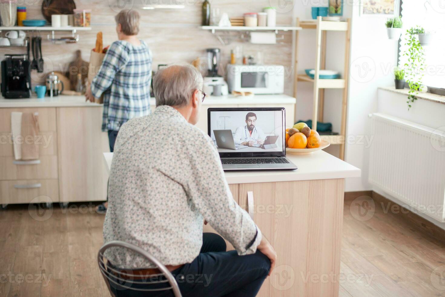 Senior couple having a video conference with doctor talking ill treatment. Online health consultation for elderly people drugs ilness advice on symptoms, physician telemedicine webcam. Medical care internet chat photo