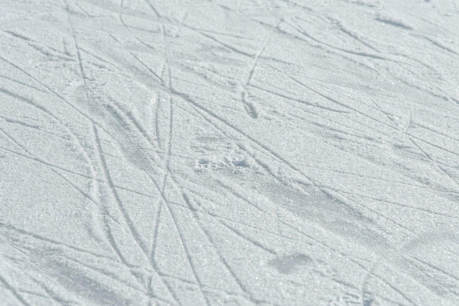 traces on the ice from skates on the rink photo