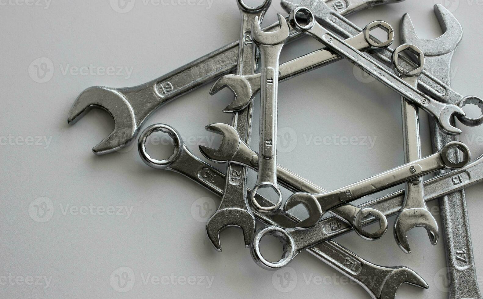 Arranged in the straight geometric shape variety ring wrenches, box end spanners and hex wrenches and on white surface photo