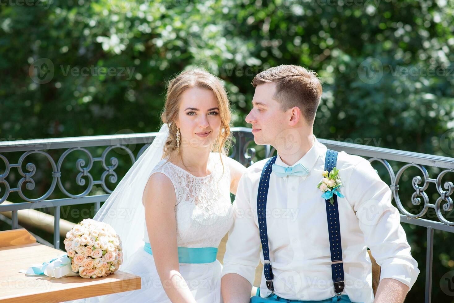 the bride and groom pose for the camera photo