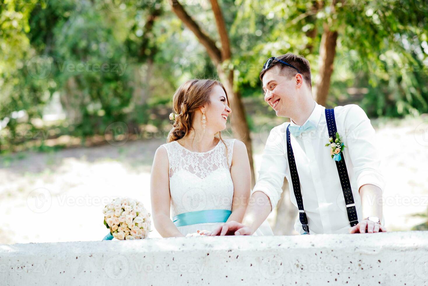 the bride and groom pose for the camera photo