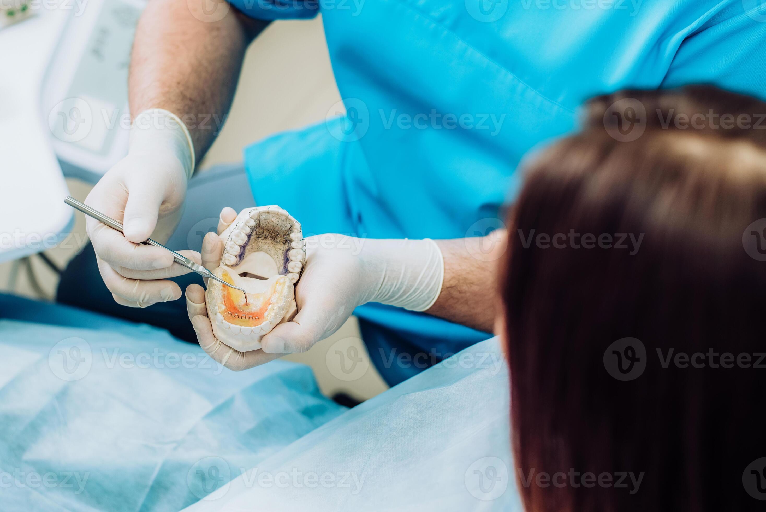 doctor orthodontist showed how the plate works to flatten teeth on the