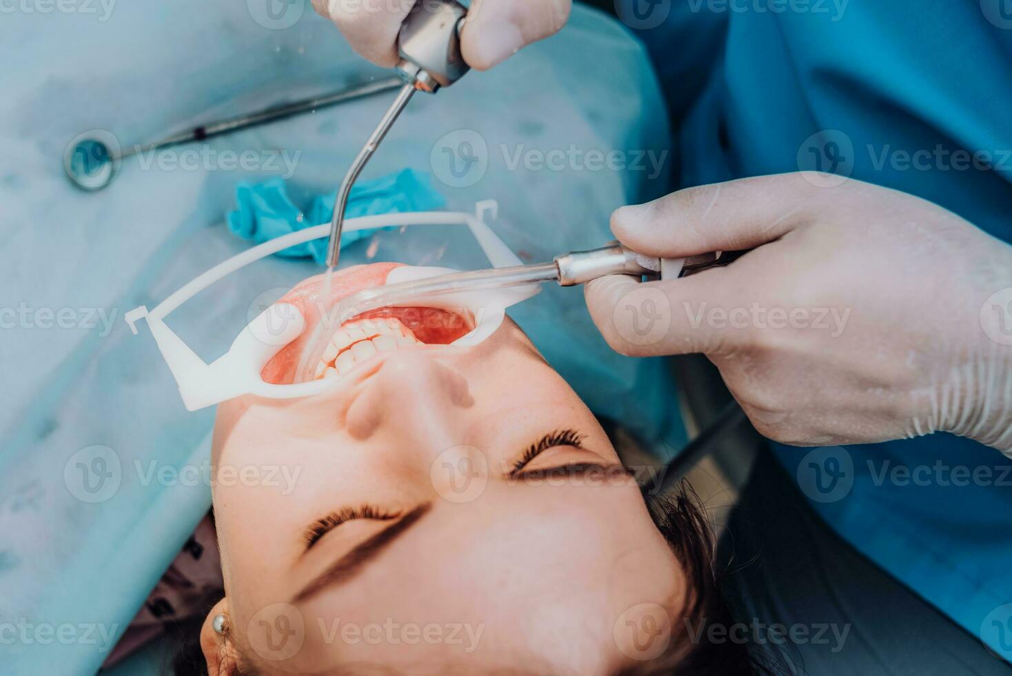 médico ortodoncista realiza un procedimiento para limpieza dientes foto