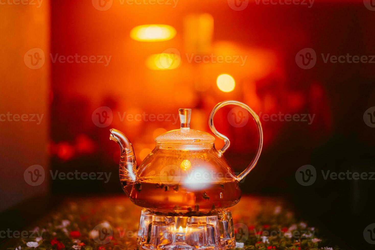 green tea brewed in a transparent teapot is on the table in a cafe photo