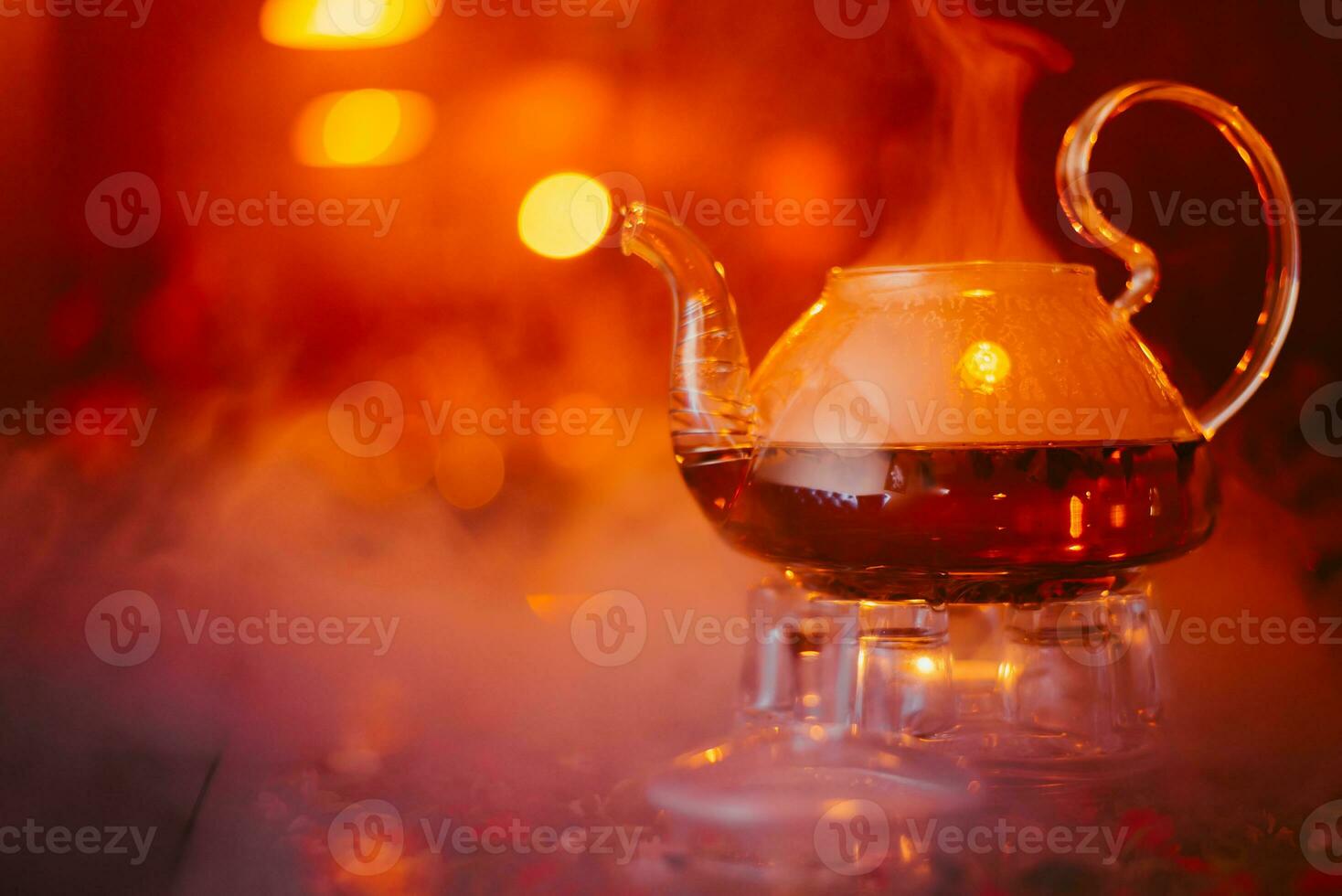 green tea brewed in a transparent teapot is on the table in a cafe photo