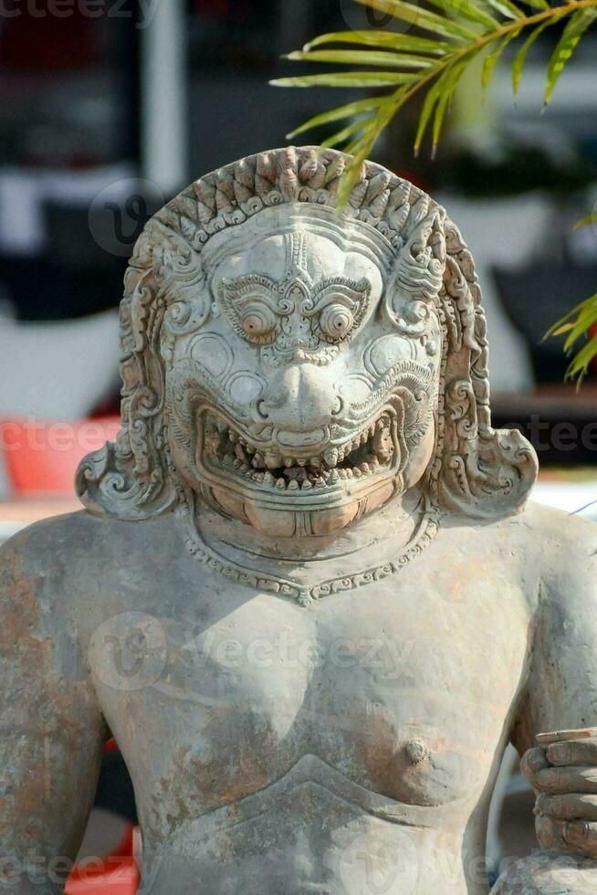 a statue of a lion with a smile on its face photo