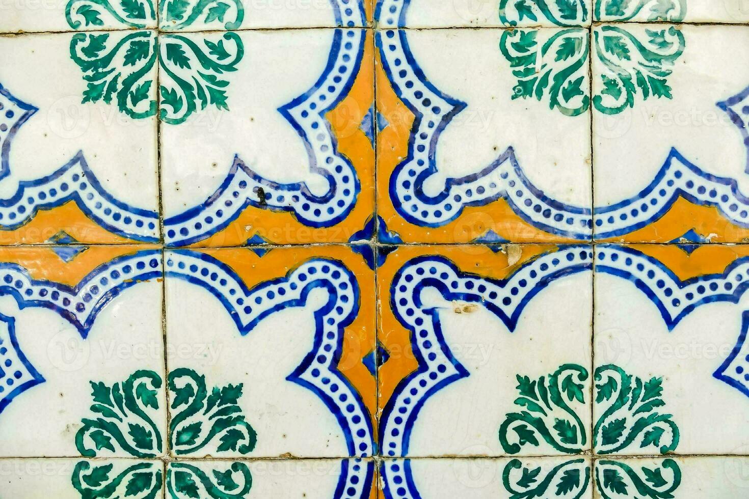 a close up of a colorful tile with a cross design photo