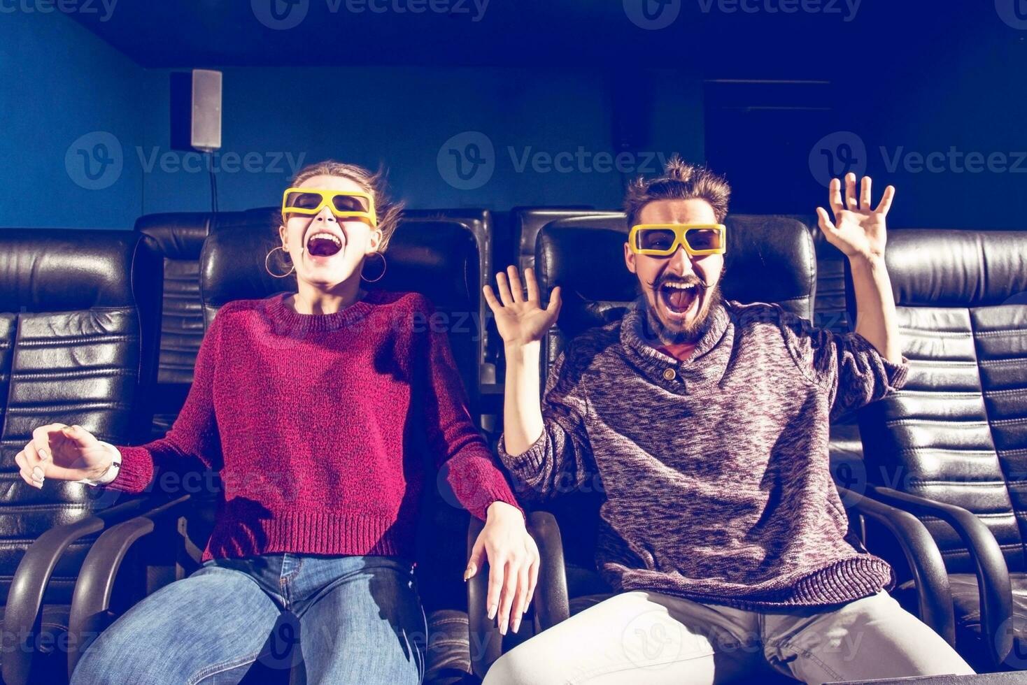 guy and girl 3d glasses are very worried while watching a movie in a cinema photo