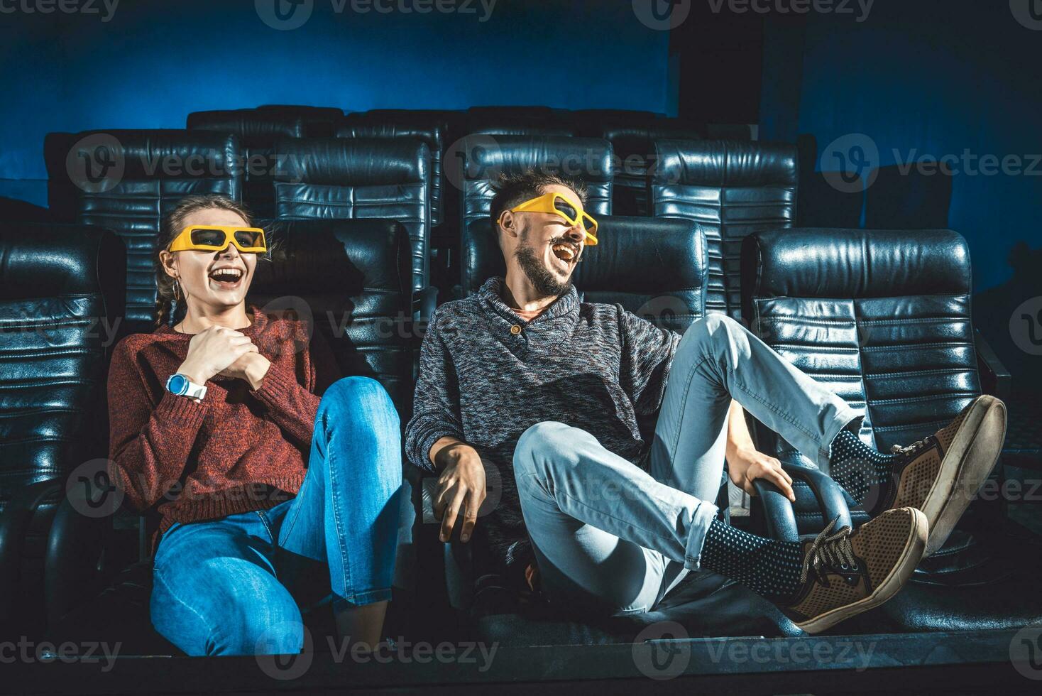 guy and girl 3d glasses are very worried while watching a movie in a cinema photo