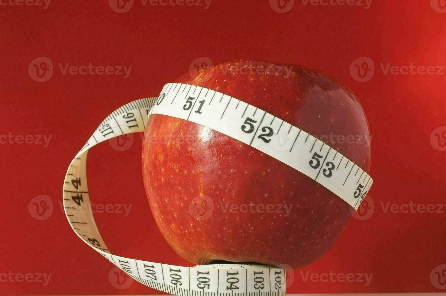 an apple with a measuring tape around it photo