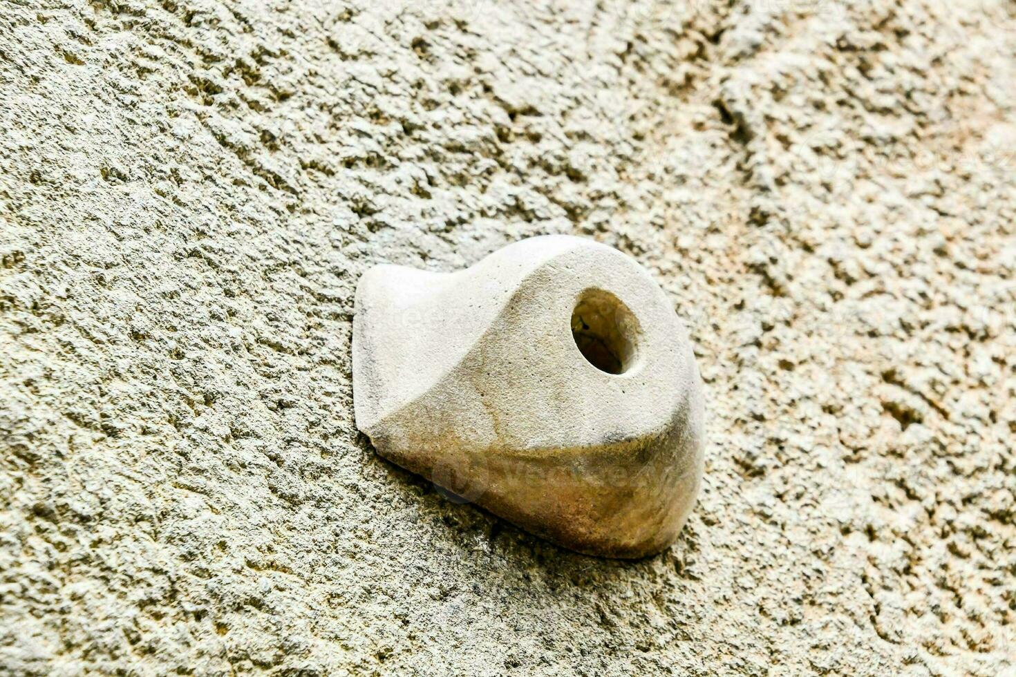 a small stone is attached to a wall photo