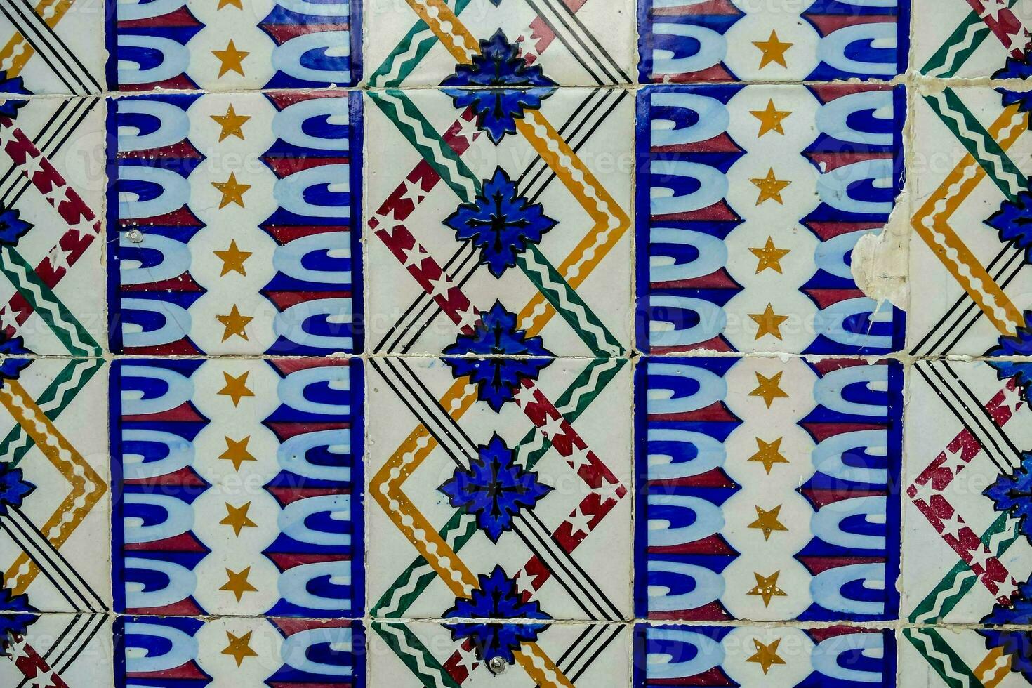 a close up of a tile with a flower design photo