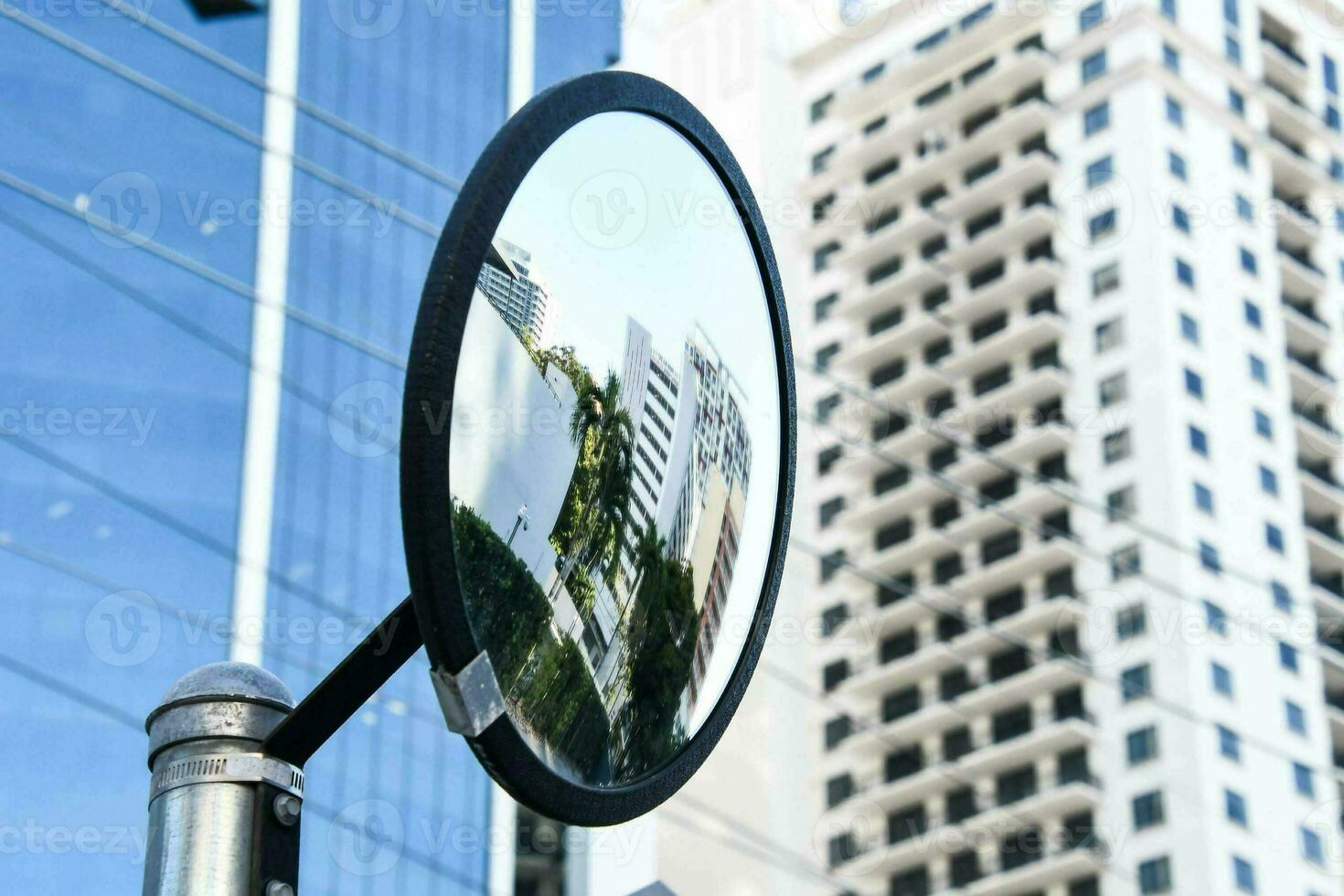 a mirror is shown in front of a building photo