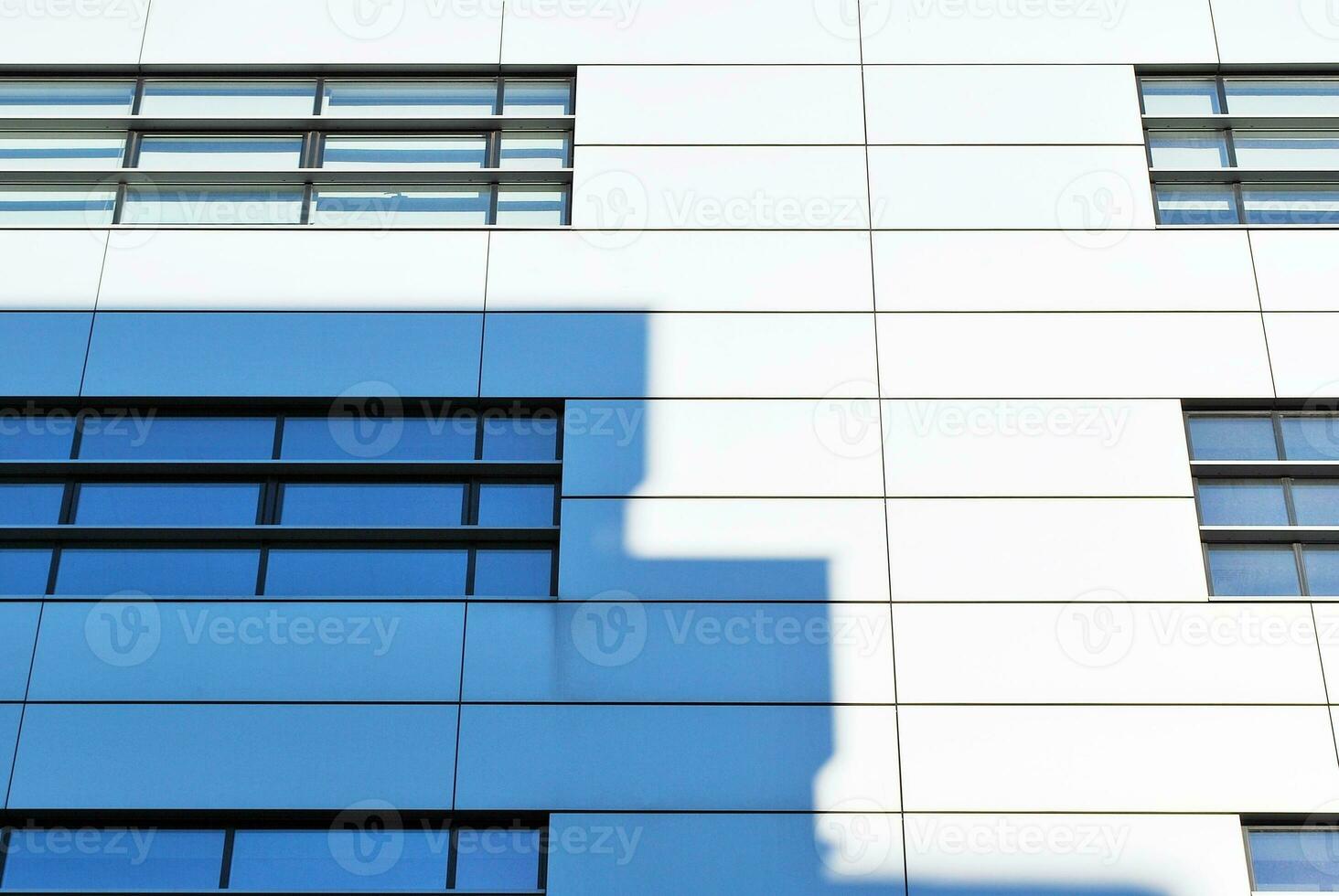 Modern office building in the city with windows and  steel and aluminum panels wall. photo