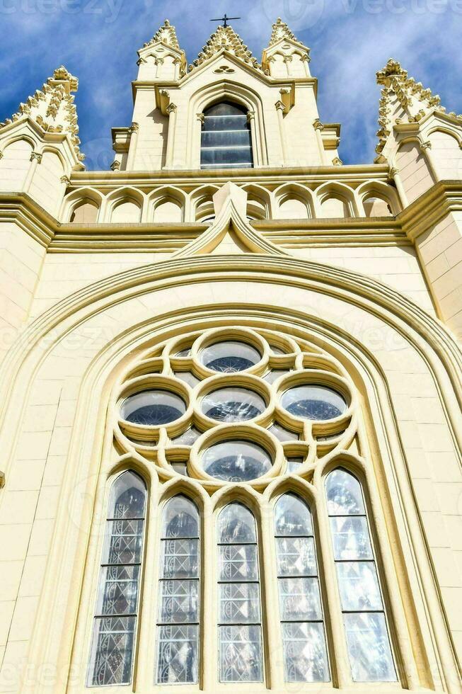 a church with a large window and a steeple photo