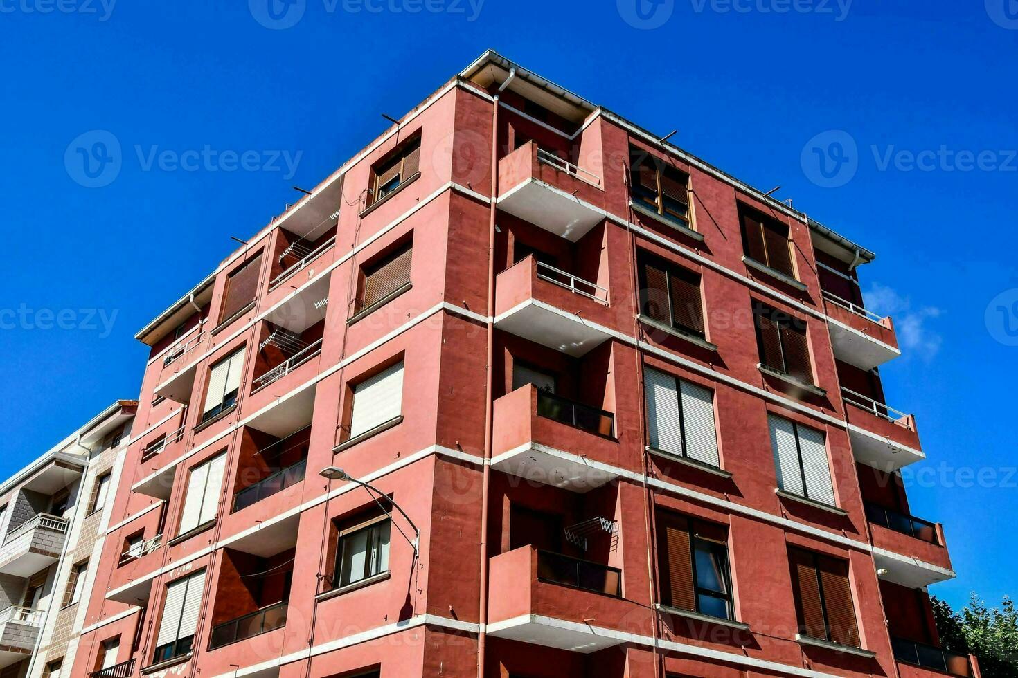 a red apartment building with balconies photo