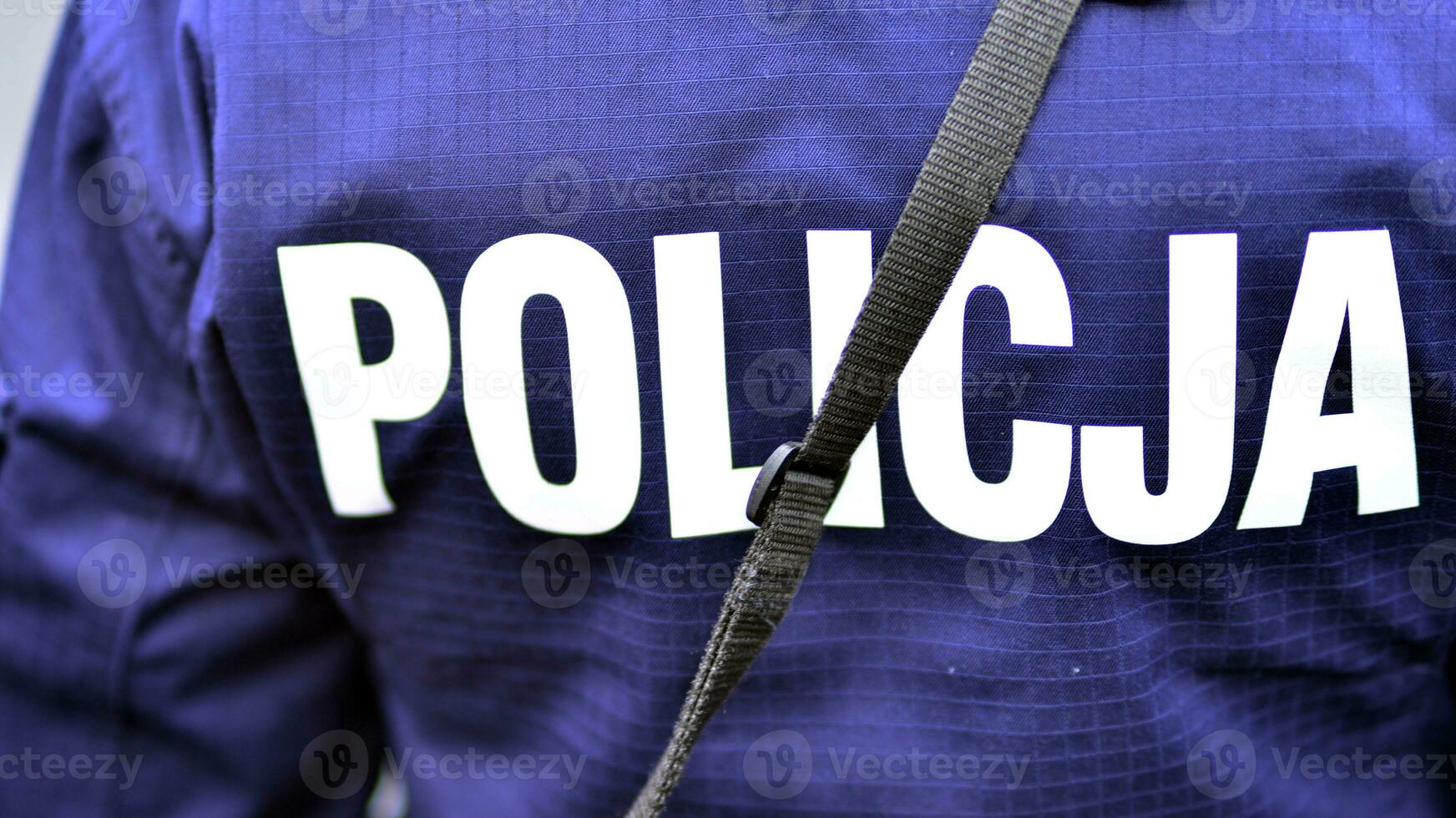 Police sign - logo on the back of the police uniform. Policja. photo