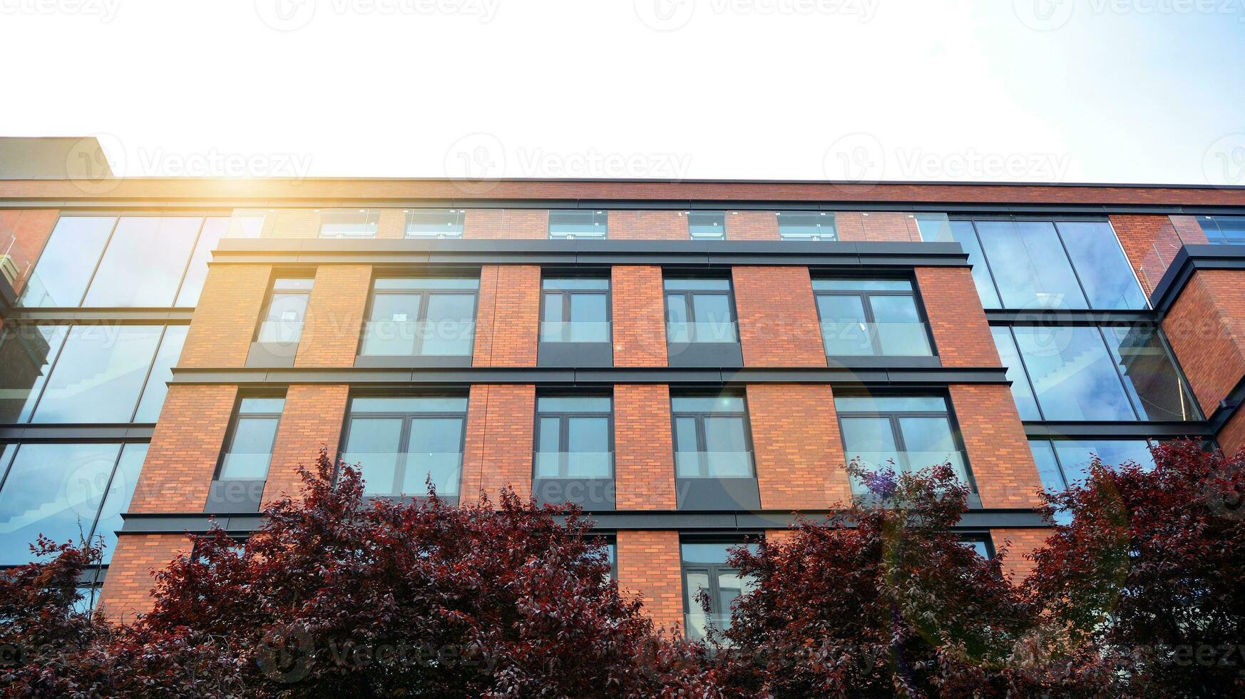 Brand new apartment building on sunny day. Modern residential architecture. Modern multi-family apartment house. photo