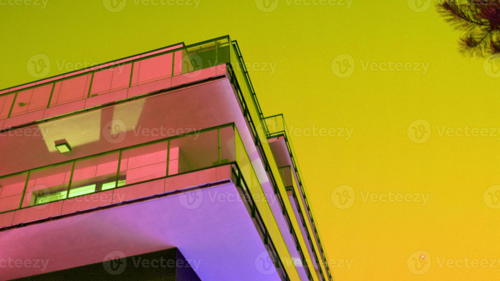 Night architecture - building with glass facade. Modern building in  business district. Concept of economics, financial. Photo of commercial office building exterior. Abstract image of office building