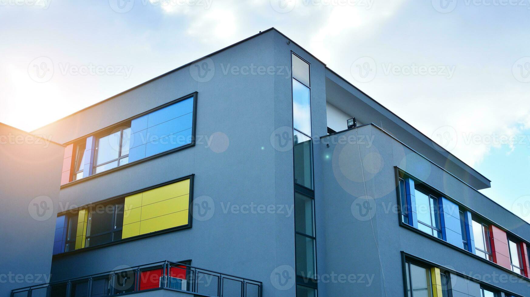 A view at a straight facade of a modern building with a dark grey facade. Dark grey metallic panel facad. Modern architectural details. photo