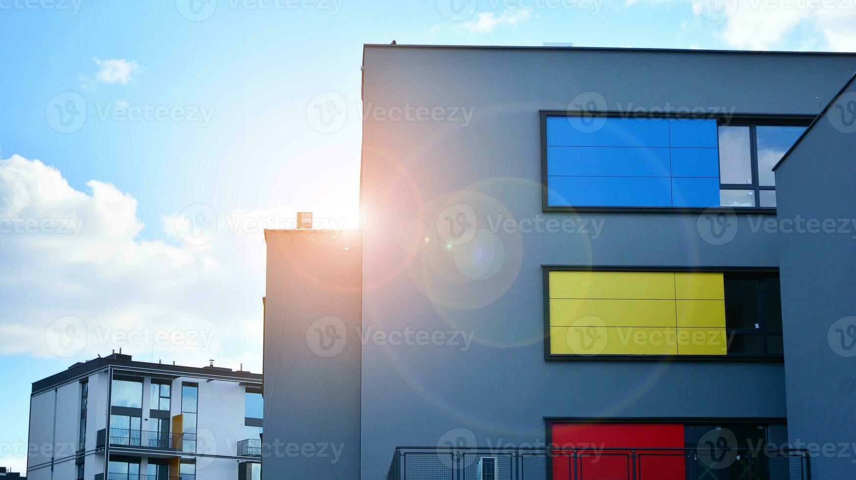 A view at a straight facade of a modern building with a dark grey facade. Dark grey metallic panel facad. Modern architectural details. photo