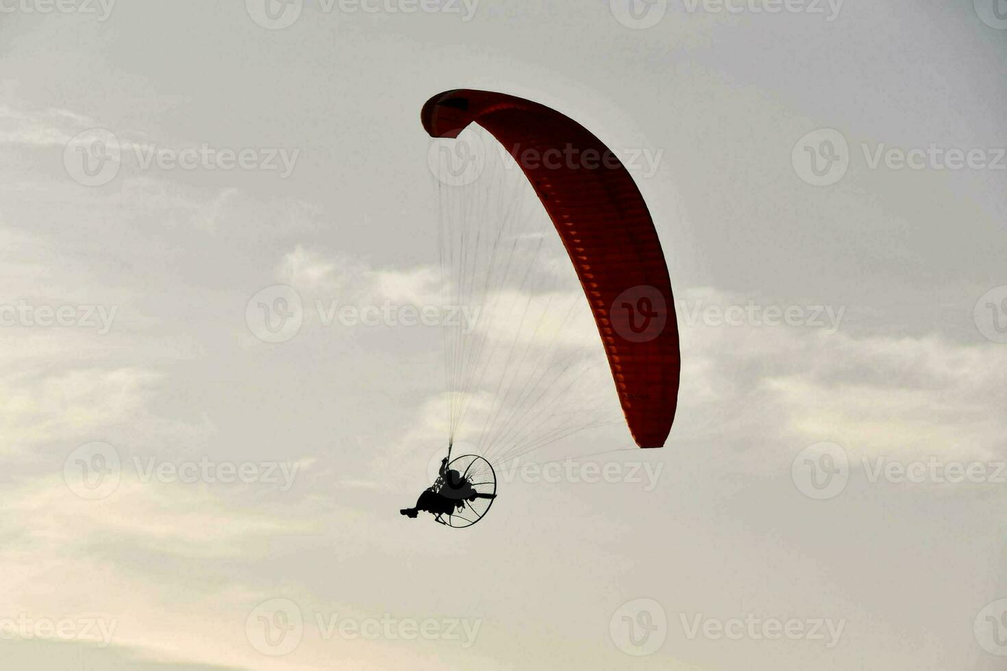 a person is paragliding in the sky photo