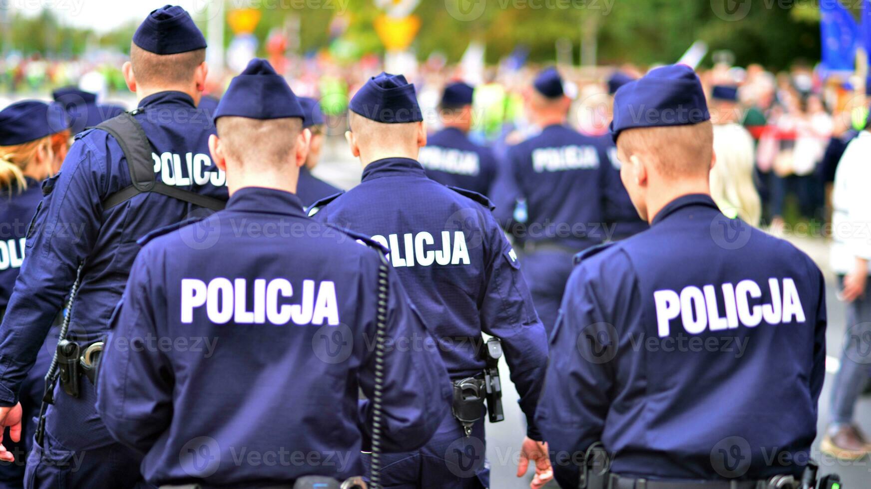 Police sign - logo on the back of the police uniform. Policja. photo