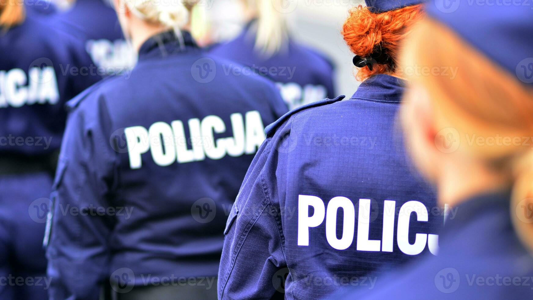 Police sign - logo on the back of the police uniform. Policja. photo