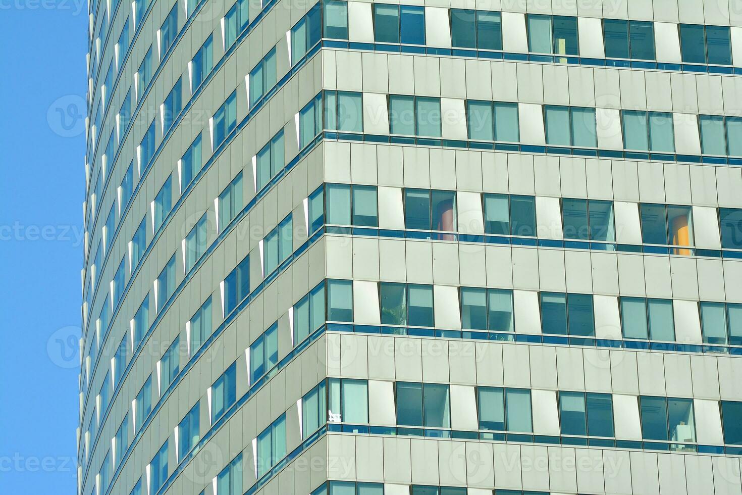 Structural glass wall reflecting blue sky. Abstract modern architecture fragment photo