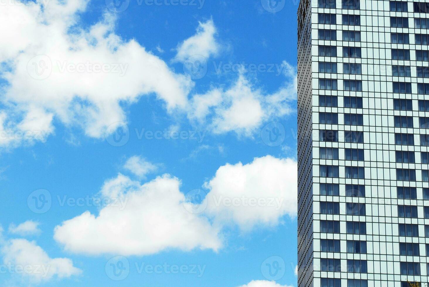 Structural glass wall reflecting blue sky. Abstract modern architecture fragment photo