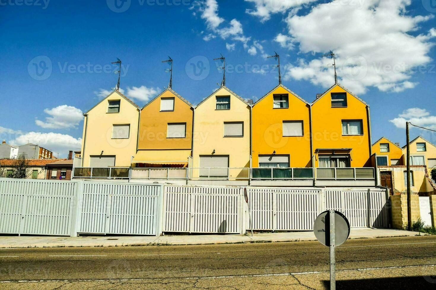 a row of yellow houses on a street photo