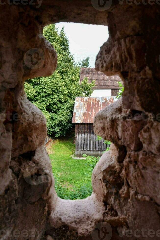 a view through a window in an old stone building photo