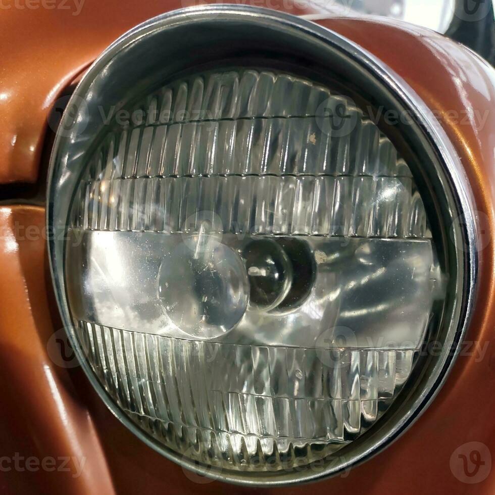 Old retro car headlight close view photo, automobile background photo