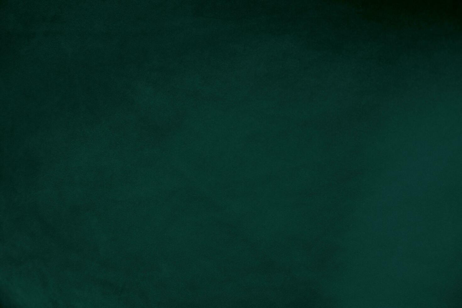 Green velvet fabric texture used as background. Emerald color panne fabric background of soft and smooth textile material. crushed velvet .luxury emerald tone for silk.. photo