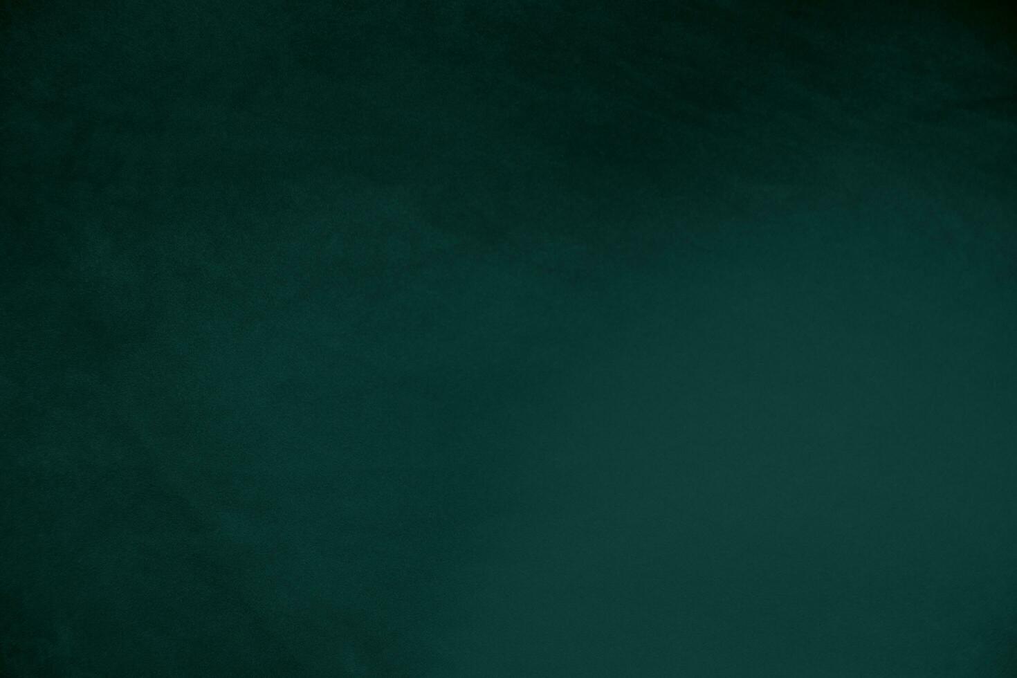 Green velvet fabric texture used as background. Emerald color panne fabric background of soft and smooth textile material. crushed velvet .luxury emerald tone for silk.. photo