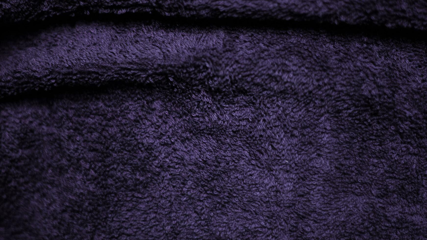 Gradient dark purple velvet fabric texture used as background. Violet color panne fabric background of soft and smooth textile material. crushed velvet .luxury magenta tone for silk.. photo