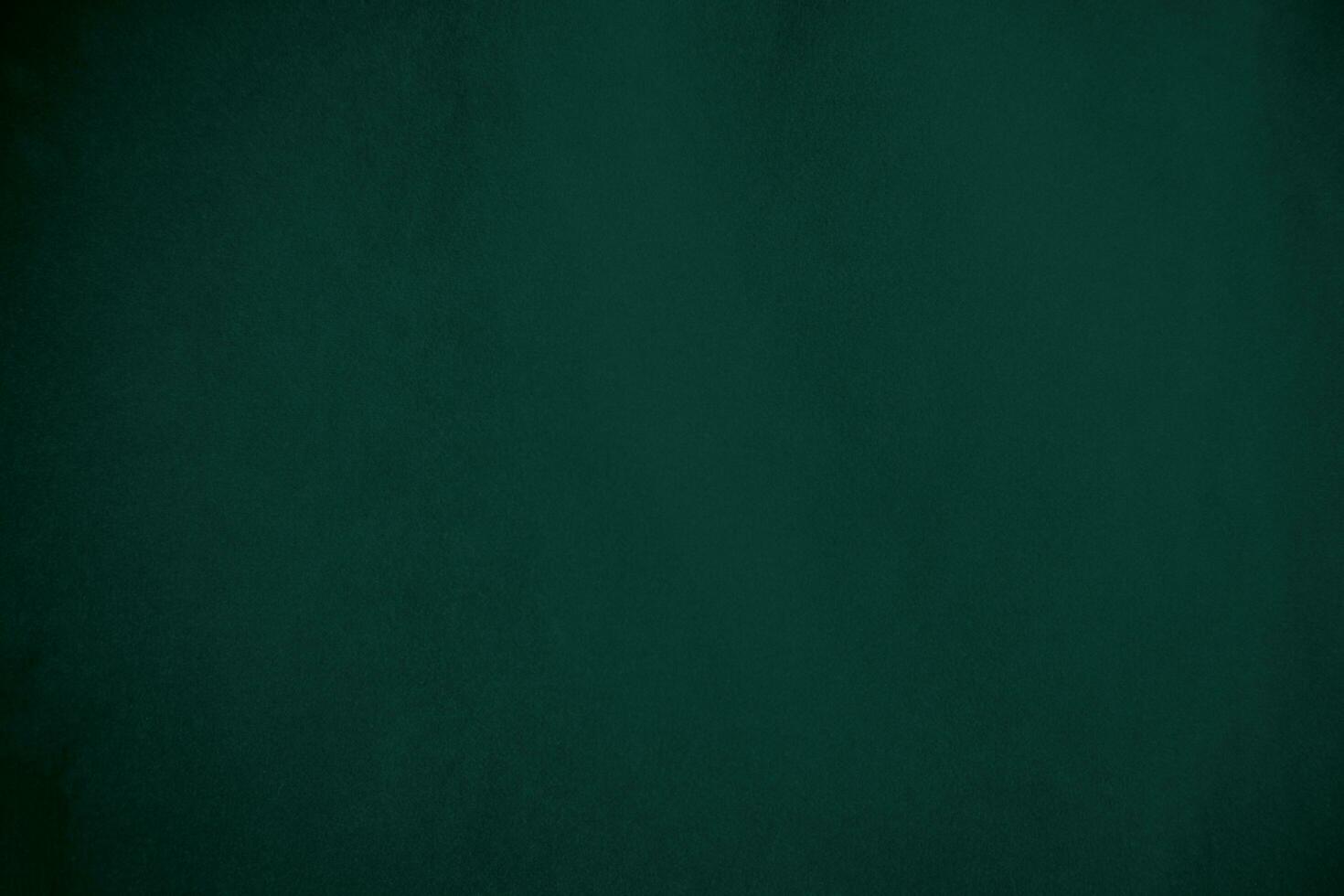 Green velvet fabric texture used as background. Emerald color panne fabric background of soft and smooth textile material. crushed velvet .luxury emerald tone for silk.. photo