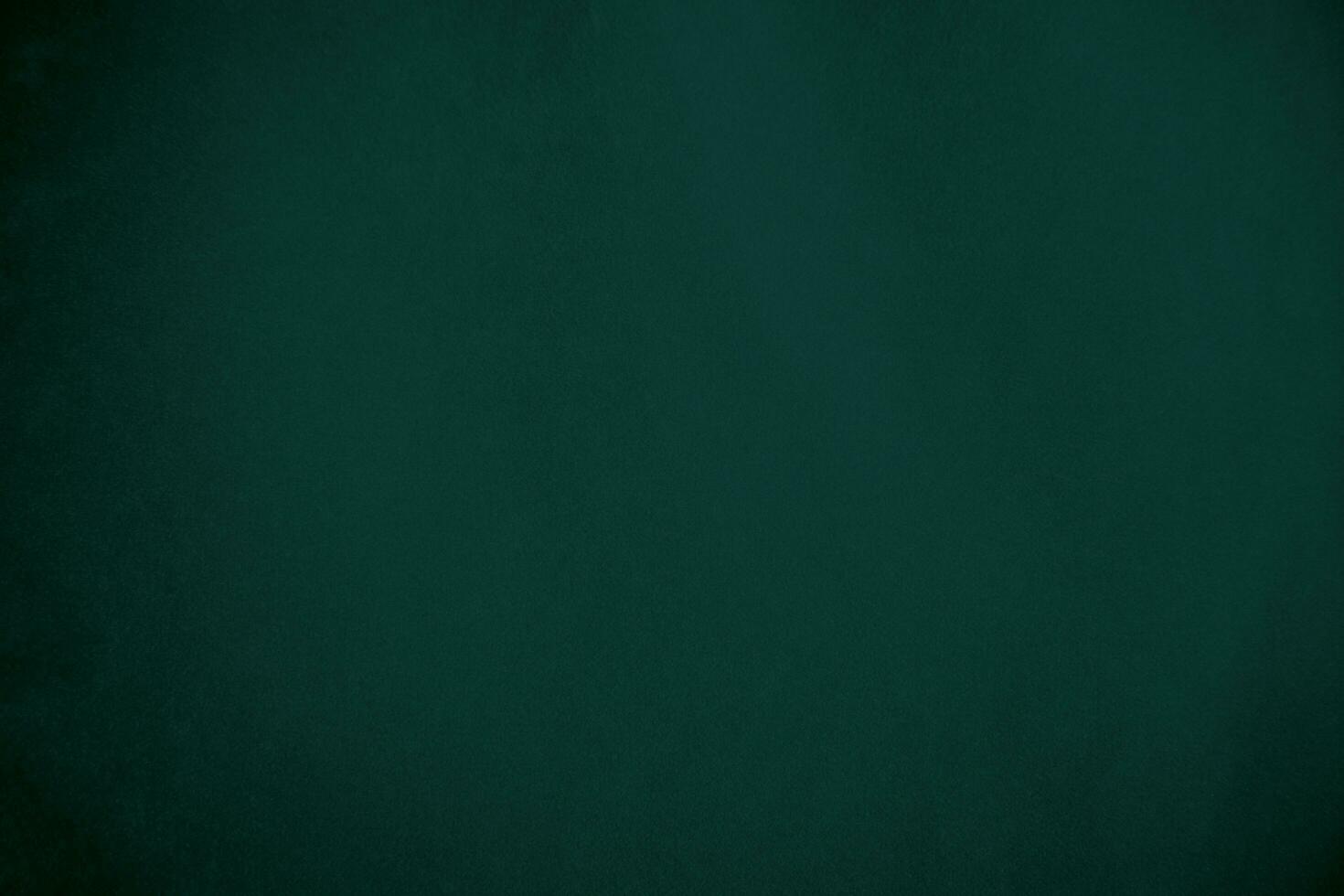 Green velvet fabric texture used as background. Emerald color panne fabric background of soft and smooth textile material. crushed velvet .luxury emerald tone for silk.. photo